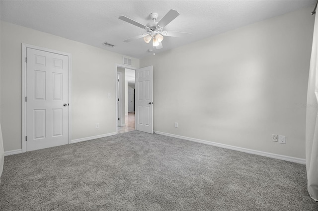 7201 Pleasant Dr, Orlando, FL 32818 - unfurnished bedroom with carpet floors, ceiling fan, and a textured ceiling