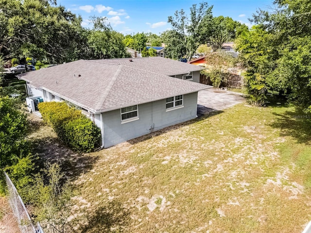 7201 Pleasant Dr, Orlando, FL 32818 - view of property exterior with a shingled roof, concrete block siding, and view of scattered trees