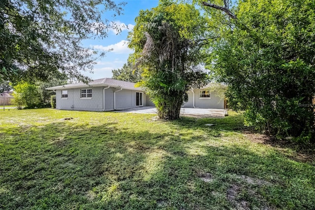 7201 Pleasant Dr, Orlando, FL 32818 - view of green lawn featuring a patio area