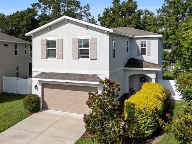 2556 Ocoee Reserve Ct, Ocoee, FL 34761 - view of front facade featuring roof with shingles, an attached garage, driveway, and stucco siding