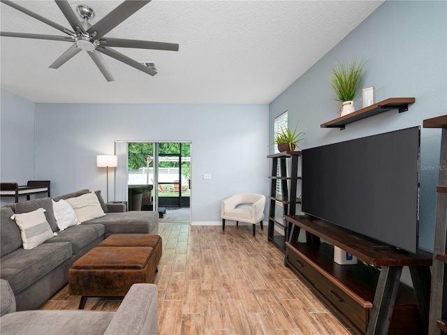 2556 Ocoee Reserve Ct, Ocoee, FL 34761 - living area featuring light wood finished floors, a ceiling fan, and a textured ceiling