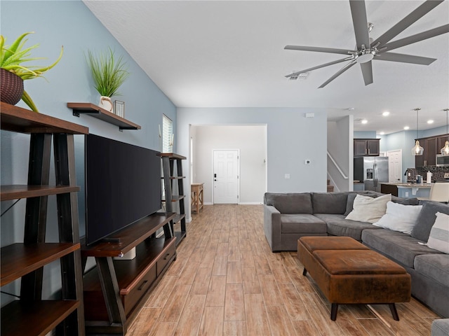 2556 Ocoee Reserve Ct, Ocoee, FL 34761 - living room featuring light wood-style flooring, stairway, a ceiling fan, and recessed lighting