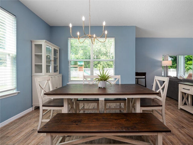 2556 Ocoee Reserve Ct, Ocoee, FL 34761 - dining space with a chandelier and light wood-style flooring