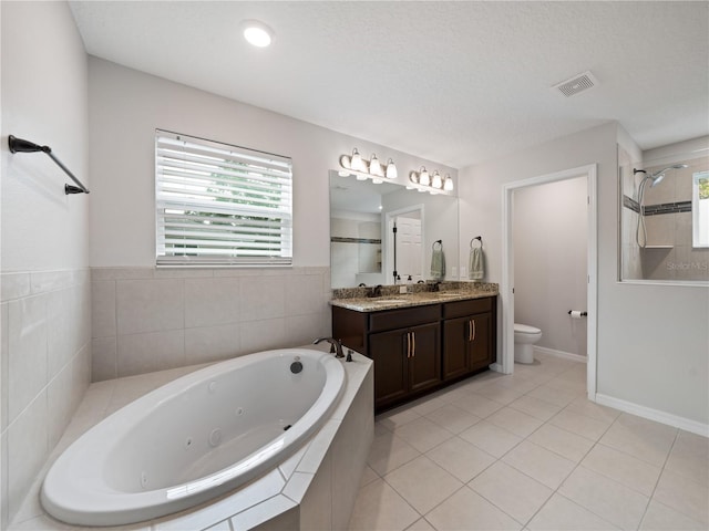 2556 Ocoee Reserve Ct, Ocoee, FL 34761 - bathroom featuring a whirlpool tub, double vanity, a tile shower, and tile patterned floors