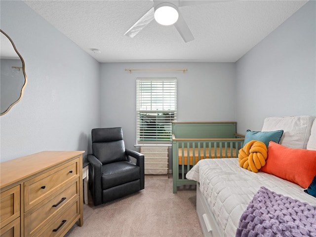 2556 Ocoee Reserve Ct, Ocoee, FL 34761 - bedroom with light carpet, a textured ceiling, and a ceiling fan
