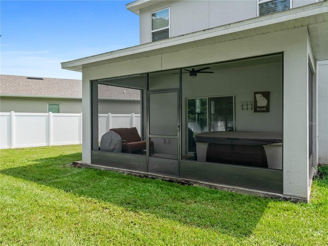 2556 Ocoee Reserve Ct, Ocoee, FL 34761 - rear view of house featuring a sunroom, stucco siding, and a ceiling fan