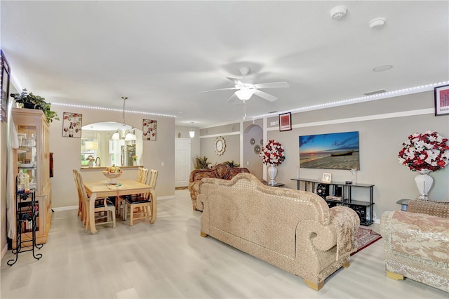 1514 Tamarind Rd, Davenport, FL 33896 - living room featuring wood finished floors, ceiling fan, and arched walkways