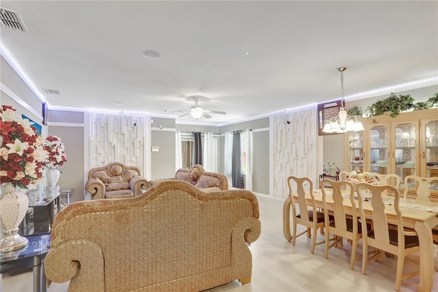 1514 Tamarind Rd, Davenport, FL 33896 - living room featuring crown molding, a ceiling fan, a chandelier, and light wood-style floors
