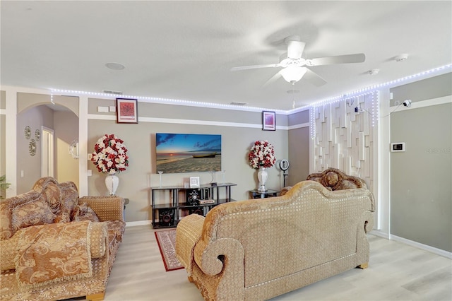 1514 Tamarind Rd, Davenport, FL 33896 - living room with light wood finished floors, arched walkways, and ceiling fan