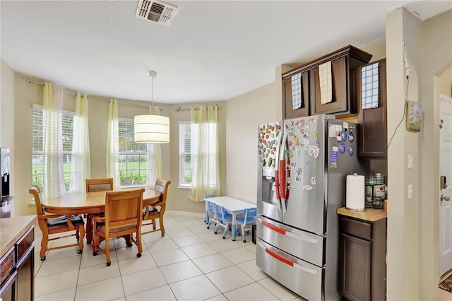 1514 Tamarind Rd, Davenport, FL 33896 - dining room with plenty of natural light and light tile patterned floors