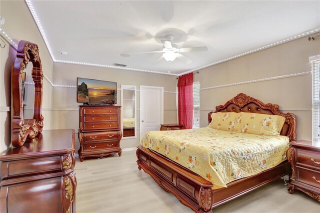 1514 Tamarind Rd, Davenport, FL 33896 - bedroom with light wood finished floors and ceiling fan