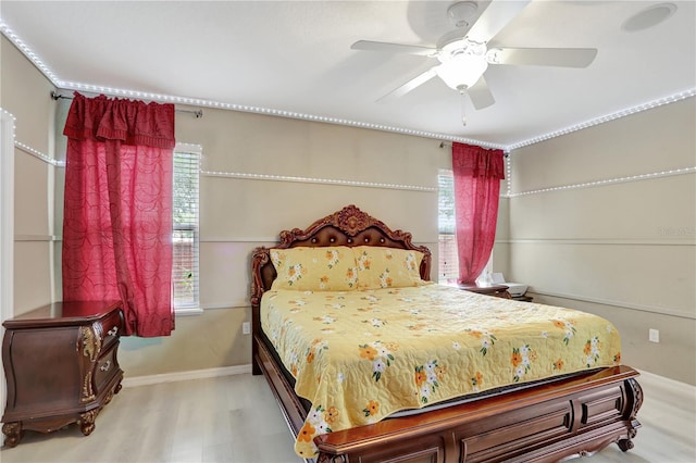 1514 Tamarind Rd, Davenport, FL 33896 - bedroom featuring multiple windows, wood finished floors, and a ceiling fan