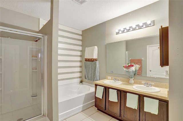 1514 Tamarind Rd, Davenport, FL 33896 - full bath with a stall shower, double vanity, a garden tub, tile patterned flooring, and a textured ceiling