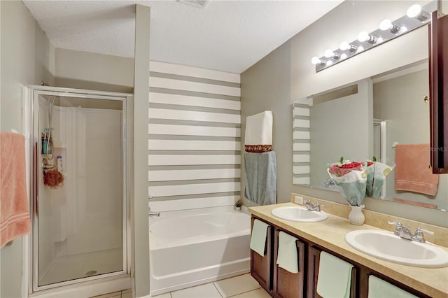 1514 Tamarind Rd, Davenport, FL 33896 - full bath featuring a stall shower, a garden tub, tile patterned floors, double vanity, and a textured ceiling