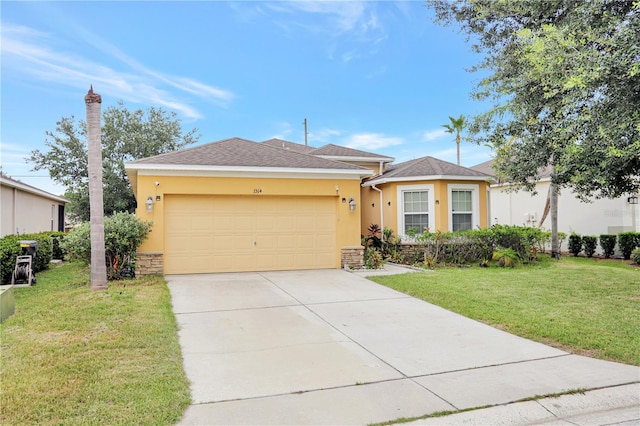 1514 Tamarind Rd, Davenport, FL 33896 - view of front of home with stucco siding, a garage, driveway, stone siding, and a front lawn
