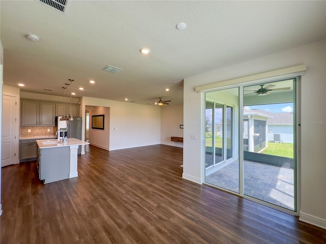 7484 Catania Loop, Clermont, FL 34714 - kitchen with a ceiling fan, light countertops, dark wood-style floors, an island with sink, and recessed lighting