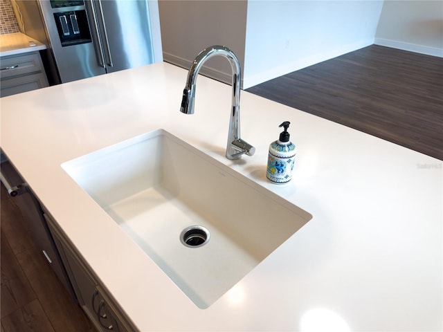 7484 Catania Loop, Clermont, FL 34714 - detailed view of stainless steel refrigerator, light countertops, and dark wood finished floors