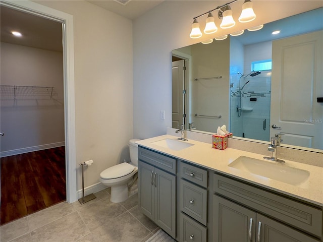 7484 Catania Loop, Clermont, FL 34714 - bathroom featuring a shower stall, double vanity, a walk in closet, tile patterned flooring, and recessed lighting