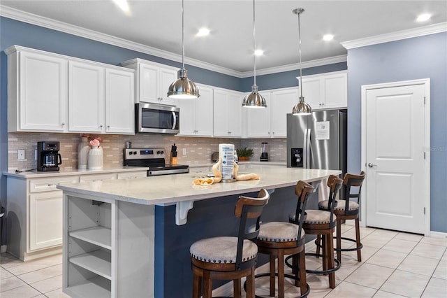 2026 Lelani Cir, Davenport, FL 33897 - kitchen with appliances with stainless steel finishes, light tile patterned flooring, white cabinetry, a kitchen island, and ornamental molding