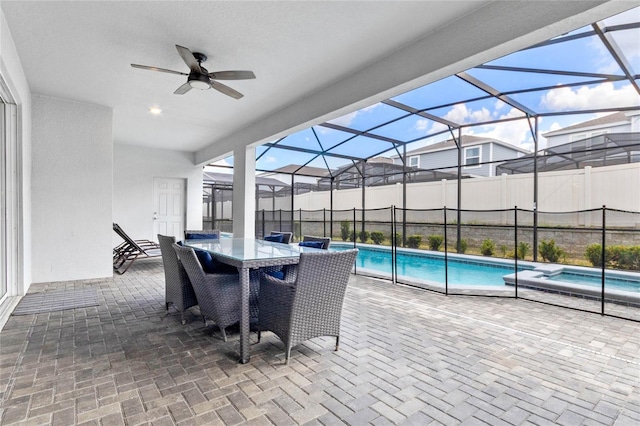 2026 Lelani Cir, Davenport, FL 33897 - view of patio featuring ceiling fan, glass enclosure, and a pool with connected hot tub