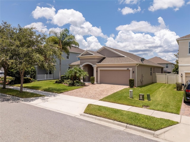 15586 Hamlin Blossom Ave, Winter Garden, FL 34787 - view of front of home featuring decorative driveway, an attached garage, stucco siding, and a shingled roof