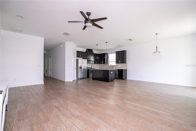 15586 Hamlin Blossom Ave, Winter Garden, FL 34787 - unfurnished living room with a ceiling fan and light wood-type flooring
