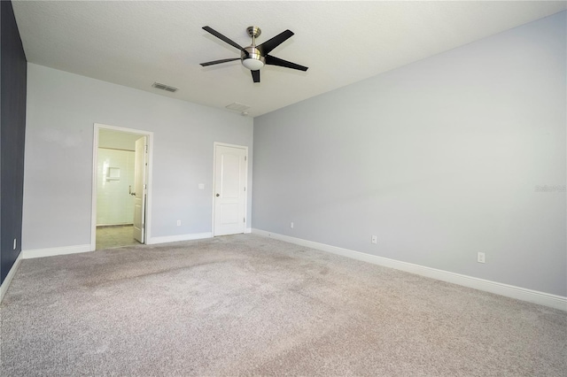 15586 Hamlin Blossom Ave, Winter Garden, FL 34787 - unfurnished bedroom featuring light colored carpet, connected bathroom, and a ceiling fan