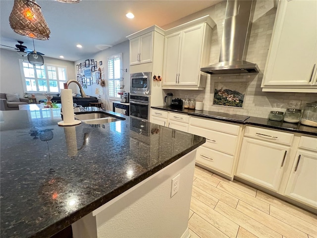 8004 Sweet Orange Ave, Winter Garden, FL 34787 - kitchen featuring wall chimney exhaust hood, appliances with stainless steel finishes, a ceiling fan, decorative backsplash, and recessed lighting