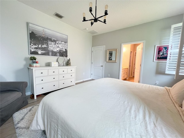 8004 Sweet Orange Ave, Winter Garden, FL 34787 - bedroom featuring a chandelier, wood finished floors, and ensuite bathroom