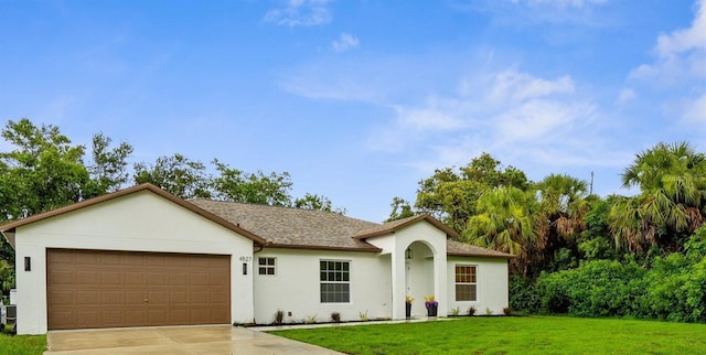 4527 Bamonte St, North Port, FL 34286 - ranch-style home with concrete driveway, an attached garage, a front lawn, and stucco siding