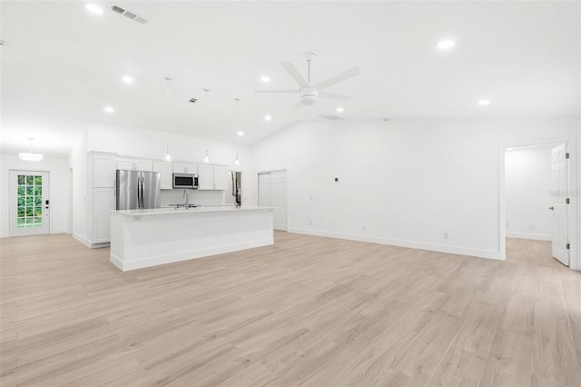 4527 Bamonte St, North Port, FL 34286 - unfurnished living room with recessed lighting, a ceiling fan, vaulted ceiling, and light wood-type flooring