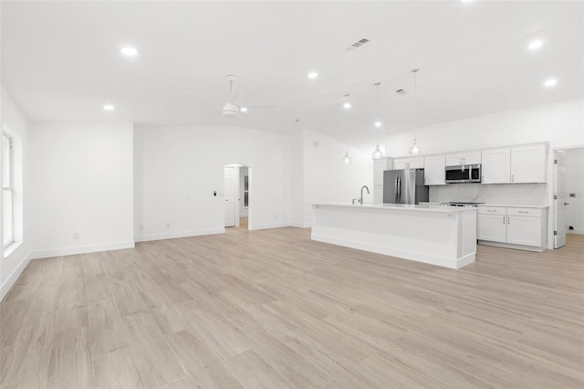 4527 Bamonte St, North Port, FL 34286 - unfurnished living room featuring arched walkways, ceiling fan, recessed lighting, and light wood-style flooring