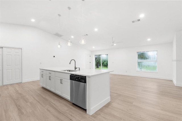 4527 Bamonte St, North Port, FL 34286 - kitchen with stainless steel dishwasher, a kitchen island with sink, light wood-type flooring, light countertops, and hanging light fixtures