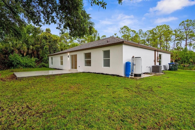 4527 Bamonte St, North Port, FL 34286 - back of property featuring stucco siding, a patio area, and a yard