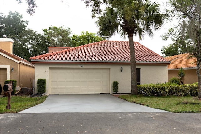 1159 E Winged Foot Cir, Winter Springs, FL 32708 - mediterranean / spanish house featuring stucco siding, driveway, a tiled roof, and an attached garage