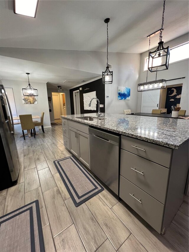 1159 E Winged Foot Cir, Winter Springs, FL 32708 - kitchen with stainless steel appliances, gray cabinets, wood tiled floors, light stone counters, and pendant lighting