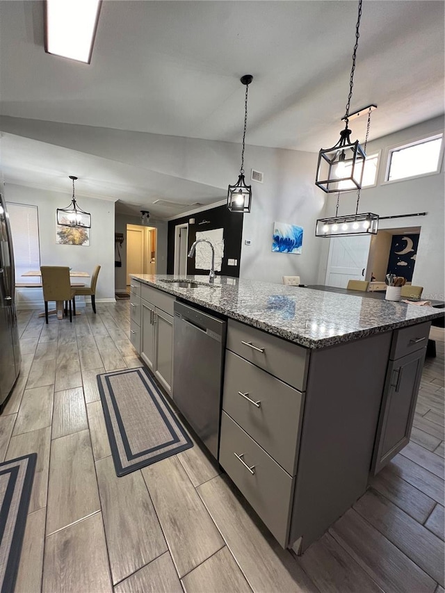 1159 E Winged Foot Cir, Winter Springs, FL 32708 - kitchen with stainless steel appliances, gray cabinets, wood tiled floors, an island with sink, and light stone countertops