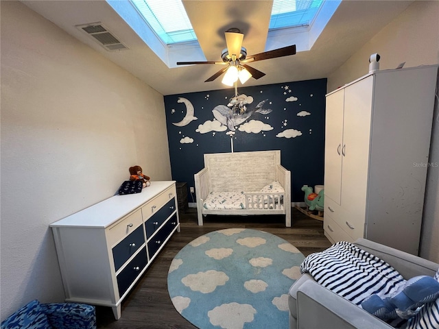 1159 E Winged Foot Cir, Winter Springs, FL 32708 - bedroom with a skylight, dark wood-style floors, an accent wall, a crib, and a ceiling fan