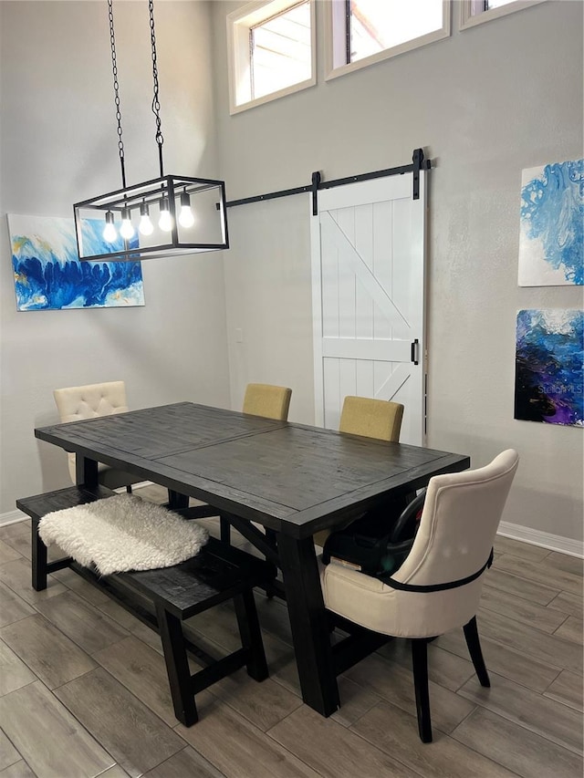 1159 E Winged Foot Cir, Winter Springs, FL 32708 - dining room with wood tiled floors and a barn door