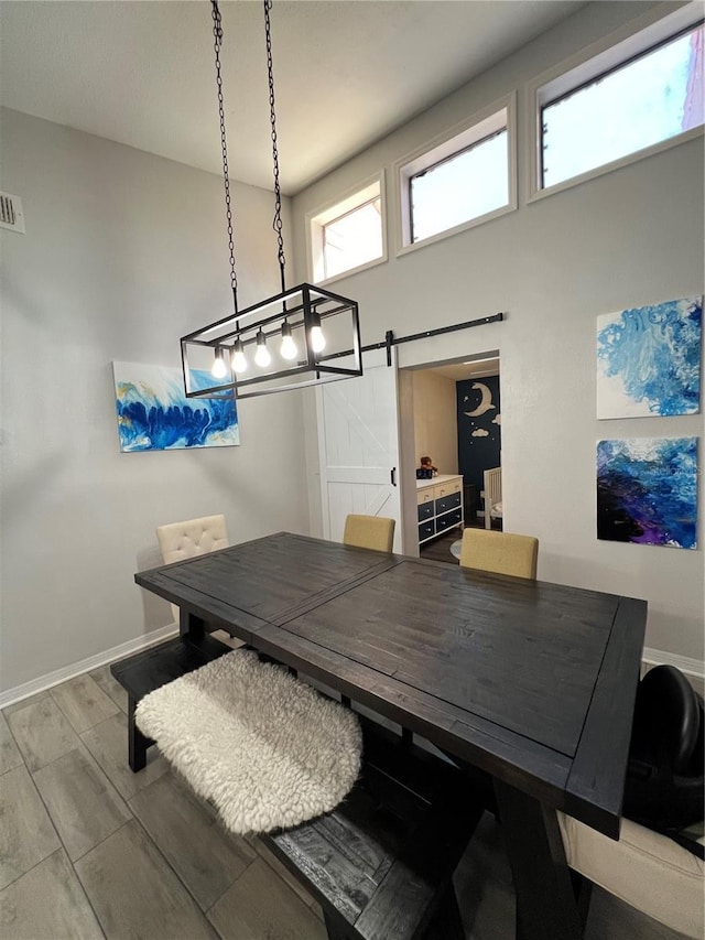 1159 E Winged Foot Cir, Winter Springs, FL 32708 - dining room featuring a barn door and wood tiled floors