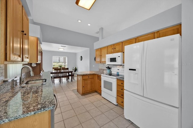 422 Harbourview Dr, Haines City, FL 33844 - kitchen with white appliances, light tile patterned floors, backsplash, dark stone countertops, and a peninsula