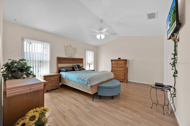 422 Harbourview Dr, Haines City, FL 33844 - bedroom featuring light wood finished floors, vaulted ceiling, and a ceiling fan