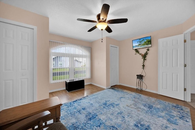 422 Harbourview Dr, Haines City, FL 33844 - bedroom with wood finished floors and a ceiling fan