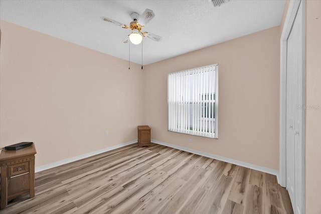 422 Harbourview Dr, Haines City, FL 33844 - unfurnished room with wood finished floors, ceiling fan, and a textured ceiling