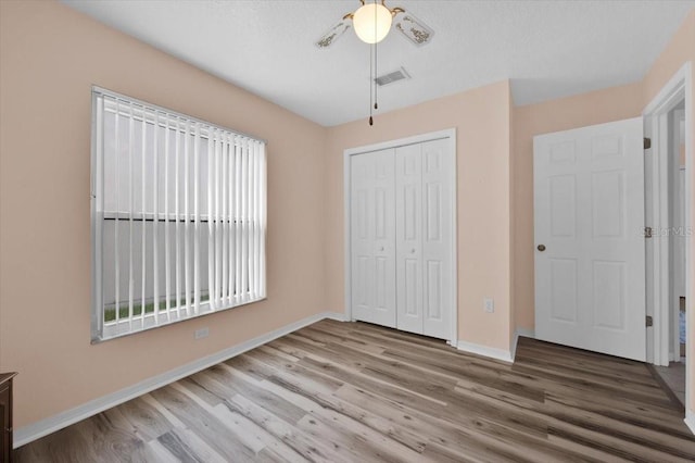 422 Harbourview Dr, Haines City, FL 33844 - unfurnished bedroom with wood finished floors and a closet