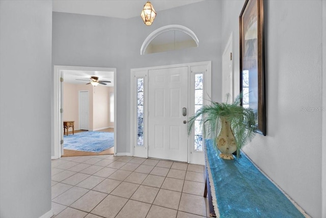 422 Harbourview Dr, Haines City, FL 33844 - foyer entrance with light tile patterned floors, a towering ceiling, and a ceiling fan