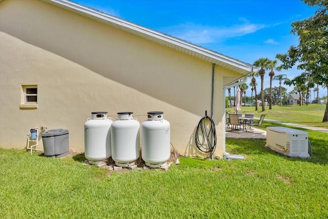422 Harbourview Dr, Haines City, FL 33844 - view of home's exterior with a yard, stucco siding, and a patio