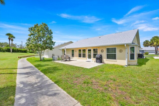 422 Harbourview Dr, Haines City, FL 33844 - rear view of house with a patio area, a yard, and stucco siding