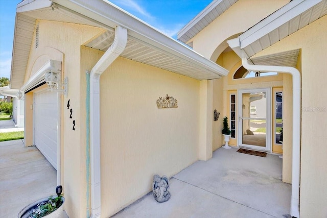 422 Harbourview Dr, Haines City, FL 33844 - view of exterior entry featuring stucco siding and a garage