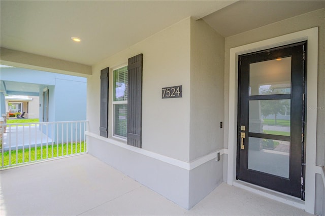 7524 Summerlake Groves St, Winter Garden, FL 34787 - property entrance with a porch and stucco siding